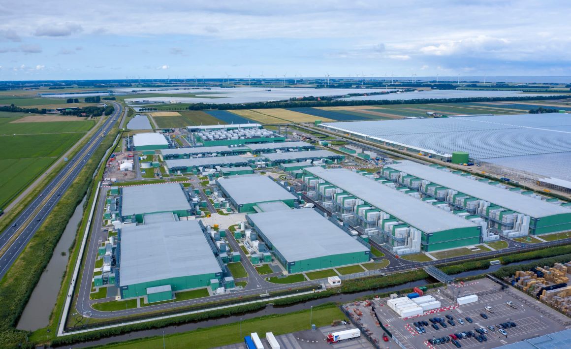 Data center buildings surrounded by green fields