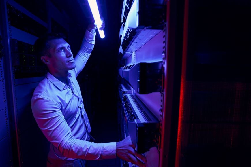 data center worker inspecting cooling system