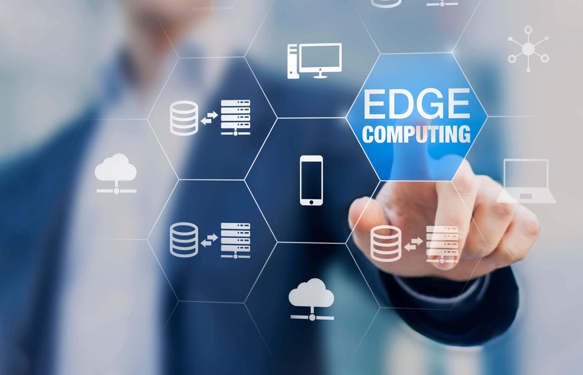 Technology icons overlay a businessman pointing at an icon that reads “edge computing”