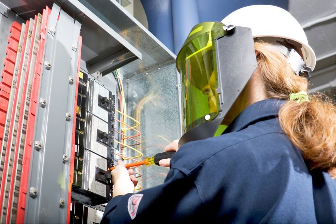 Electrician working while wearing safety gear