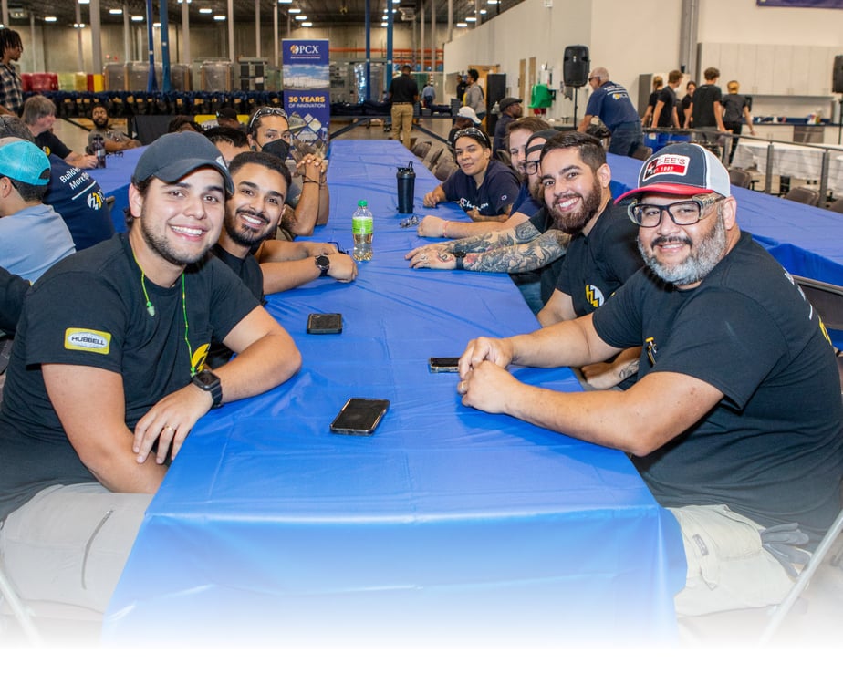 A group of PCX employees at a table celebrating the 30th anniversary of the company